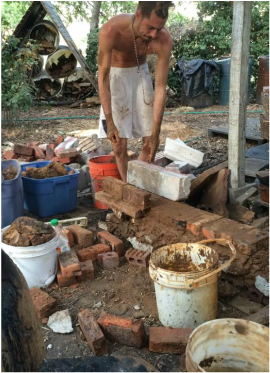 Quinn Eaker building a rocket stove